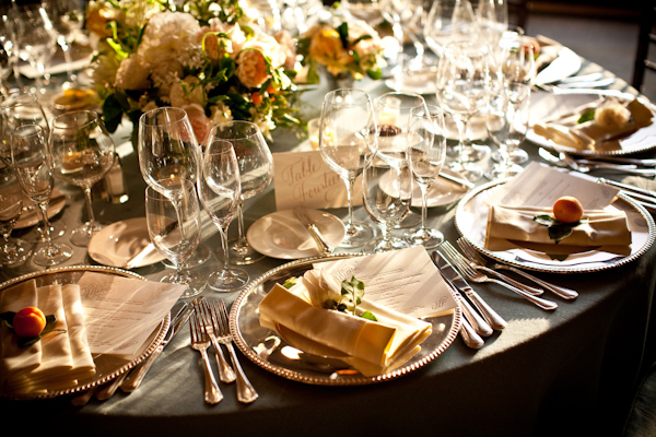 table top with gold plates and orange accents, real wedding photo by Los Angeles photographer Jay Lawrence Goldman